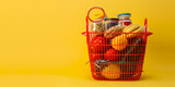 Shopping cart full of groceries on yellow background Happy family with shopping cart full of groceries on yellow background.