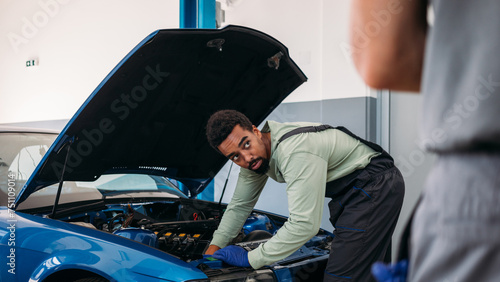 Two Mechanics Repairing Car photo