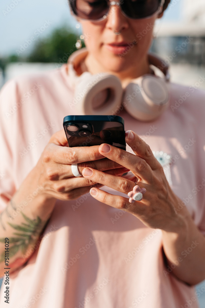 Young woman in sunglasses using smartphone Young woman in sunglasses using smartphone