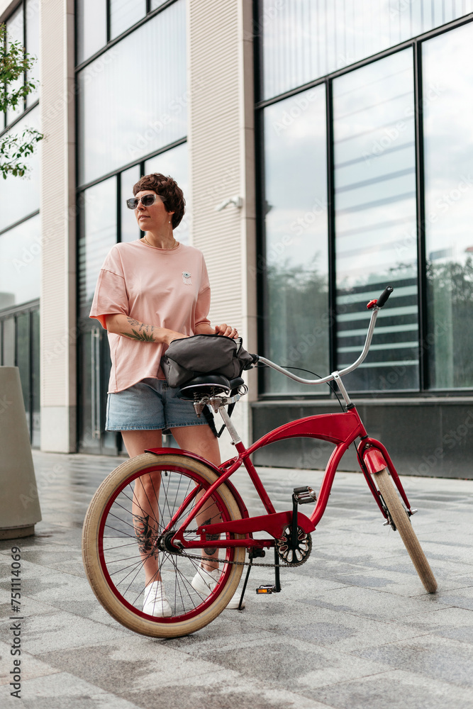 Young woman with bicycle on street Young woman with bicycle on street