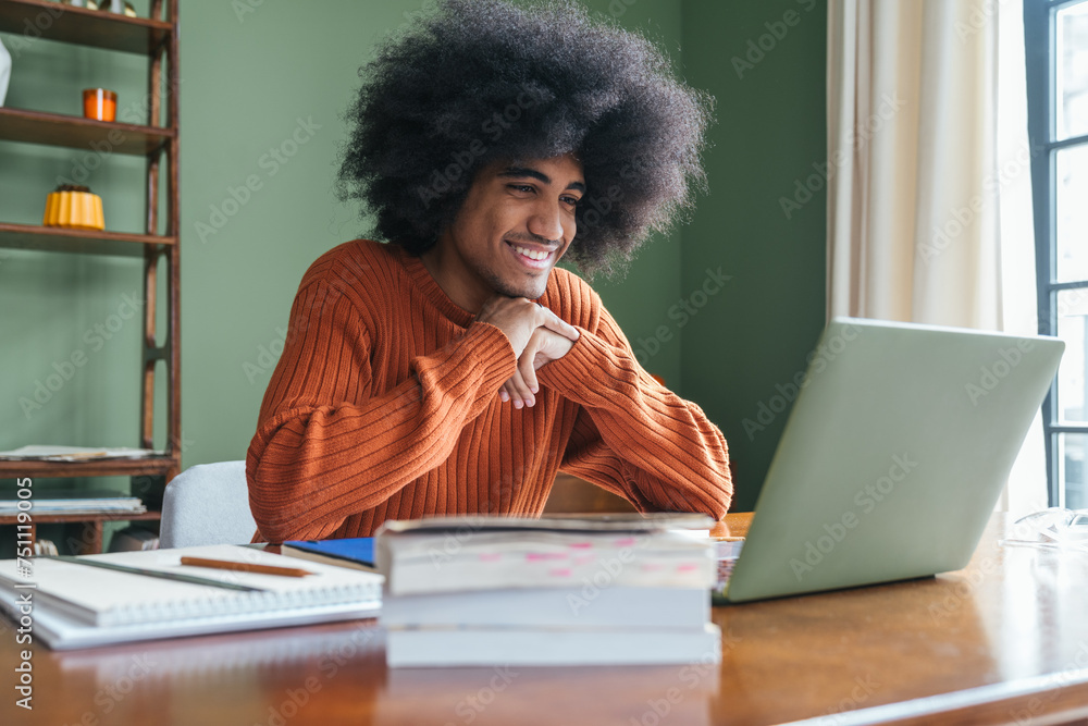 © Basil Pind/Stocksy - male student with afro hair learning © Basil Pind/Stocksy - male student with afro hair learning