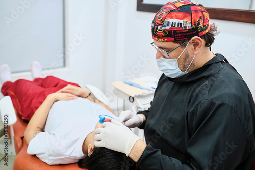 Dentist applying a dental cleaning treatment photo