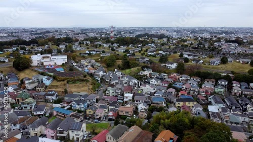 A dense colorful residential area during daylight, aerial view