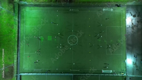 Aerial View of Football Playground with Players are Playing a Match at Night over Central Welwyn Garden City of England UK photo