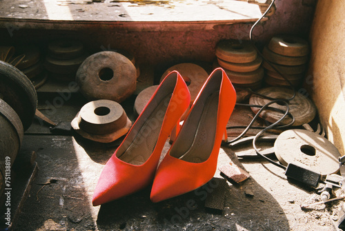 Red shoes after being repaired in a shoe repair shop  photo