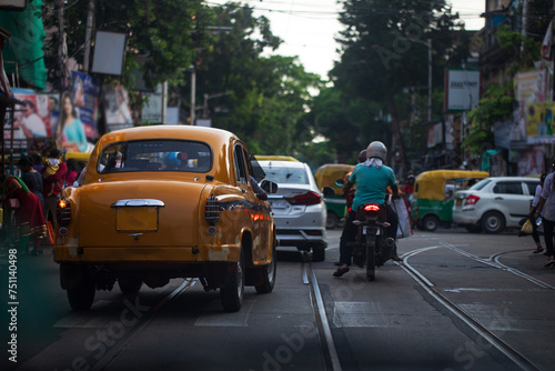 Cityscape of Kolkata with vintage yellow taxi and other  vehicles