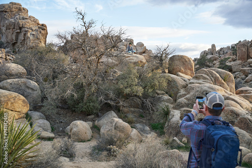 A father takes a picture of his son in Joshua Tree National Park photo