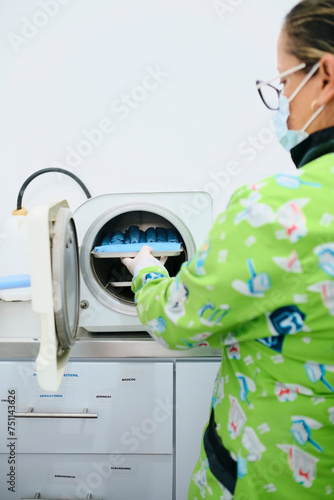 Dentist sterilizing her instruments