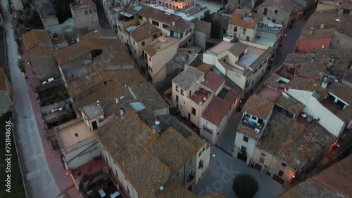 Aerial View Flying Over Rooftops In The City Of Peralada In Girona Costa Brava Towards Sant Martí Church. Descending Shot, Push Forward  photo