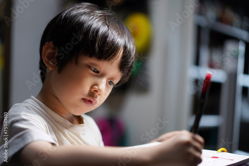 Asian boy drawing at home photo
