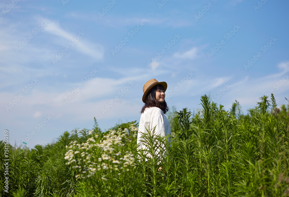 Asian woman, outdoors on the beautiful grass Asian woman, outdoors on the beautiful grass