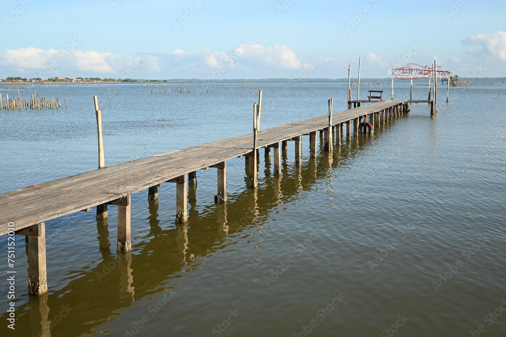 Ba Na wooden bridge Built to stretch all the way to Pattani Bay, you can take a walk to admire the atmosphere of the sea and mangrove forest. There is a pavilion for sitting. At Pattani , Thailand. Ba Na wooden bridge Built to stretch all the way to Pattani Bay, you can take a walk to admire the atmosphere of the sea and mangrove forest. There is a pavilion for sitting. At Pattani , Thailand.