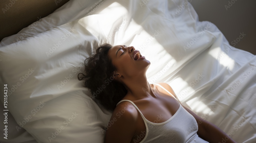 Female face during an orgasm in bed. Women's pleasure. A beautiful female with soft skin is enjoying and feels good.