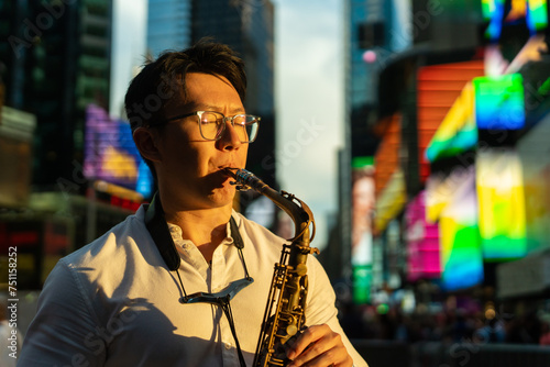 Passionate Man Playing The Saxophone On The Street At Sunset. photo