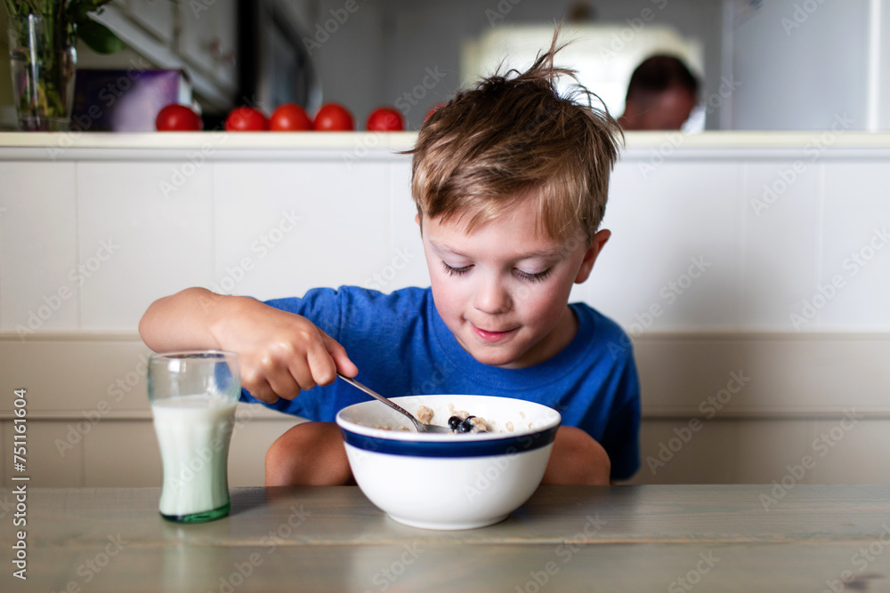 boy eating oatmeal breakfast boy eating oatmeal breakfast