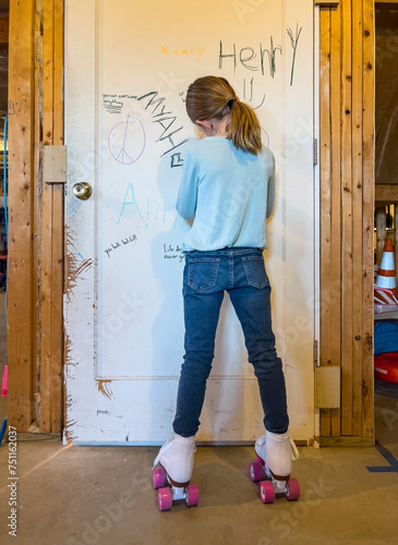 Child rollerskating in basement UGC portrait and signing door 