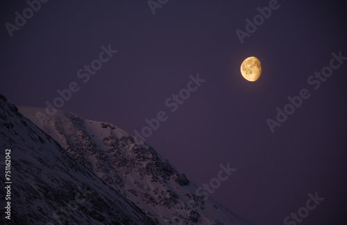 Waning gibbous moon and mountains