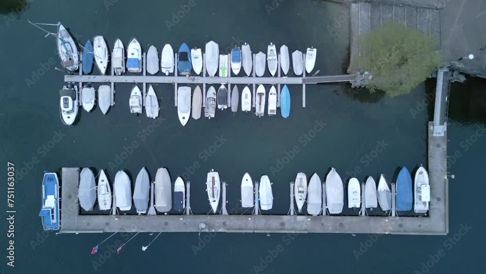 Aerial shot of a serene marina with aligned boats docked at the pier, reflecting a peaceful aquatic lifestyle. Switzerland. Slow Motion, 4K RAW. Aerial shot of a serene marina with aligned boats docked at the pier, reflecting a peaceful aquatic lifestyle. Switzerland. Slow Motion, 4K RAW.