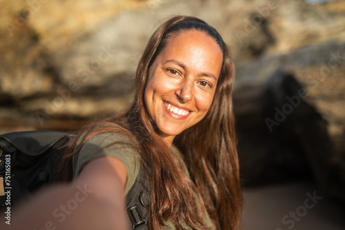 ugc selfie of tanned young woman on the beach at sunset photo