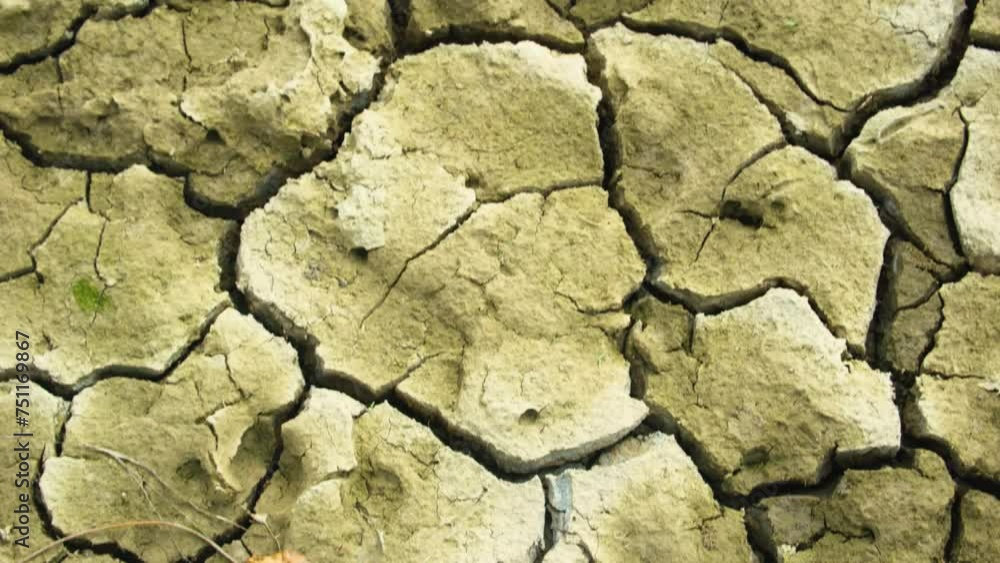 Looking down across arid cracked sandy barren yellow dehydrated ground Looking down across arid cracked sandy barren yellow dehydrated ground