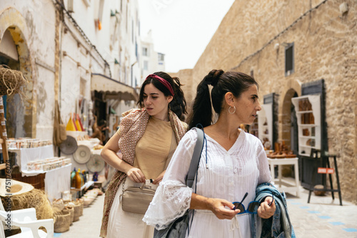 Women visiting an Arab city, looking at the street stalls. photo