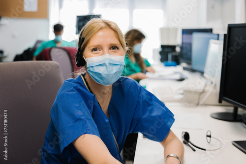 Positive female doctor in mask photo