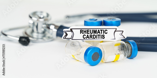 On the table there is a stethoscope, injections and a sign with the inscription - Rheumatic carditis photo