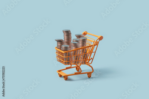 Miniature shopping cart with stacks of coins. photo