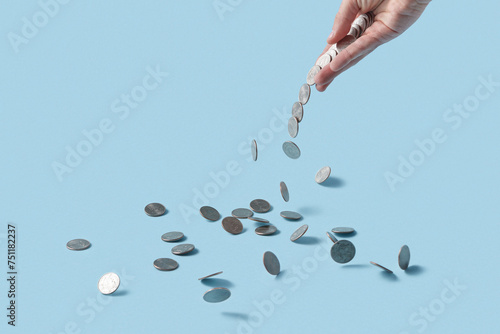 Woman's hand scattering cent coins. photo