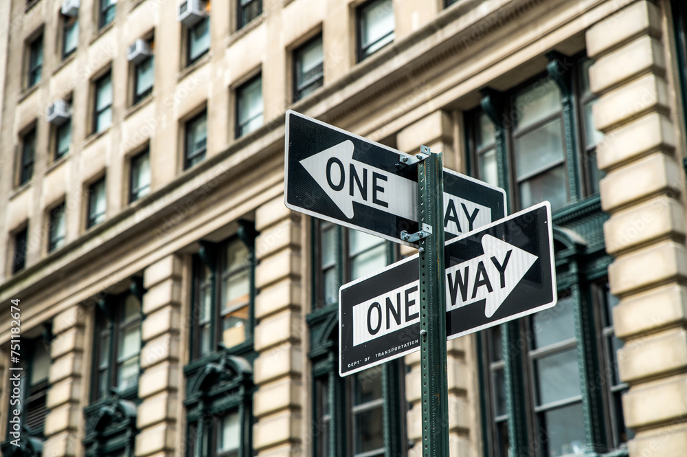 One way road signs on street near building in daylight One way road signs on street near building in daylight