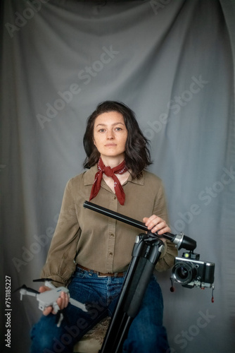 Portrait of an attractive girl with a camera and a quadcopter