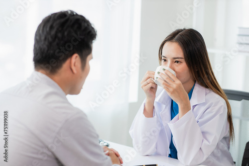 Female dentist counseling male patient at dental clinic office oral health care