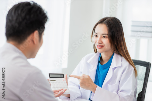 Female dentist counseling male patient at dental clinic office oral health care