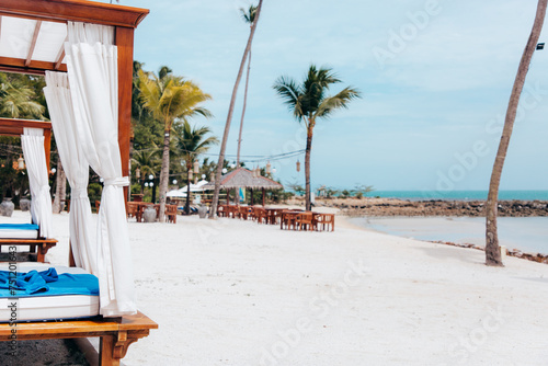 Beach cabanas on a white sandy Thai beach photo