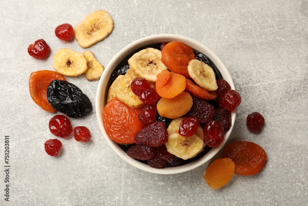 Mix of delicious dried fruits on grey table, flat lay Mix of delicious dried fruits on grey table, flat lay
