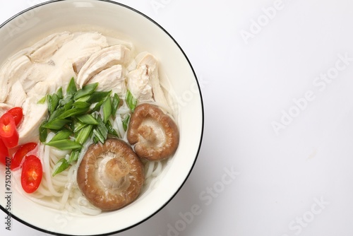 Delicious ramen with meat and mushrooms in bowl on white background, top view. Space for text