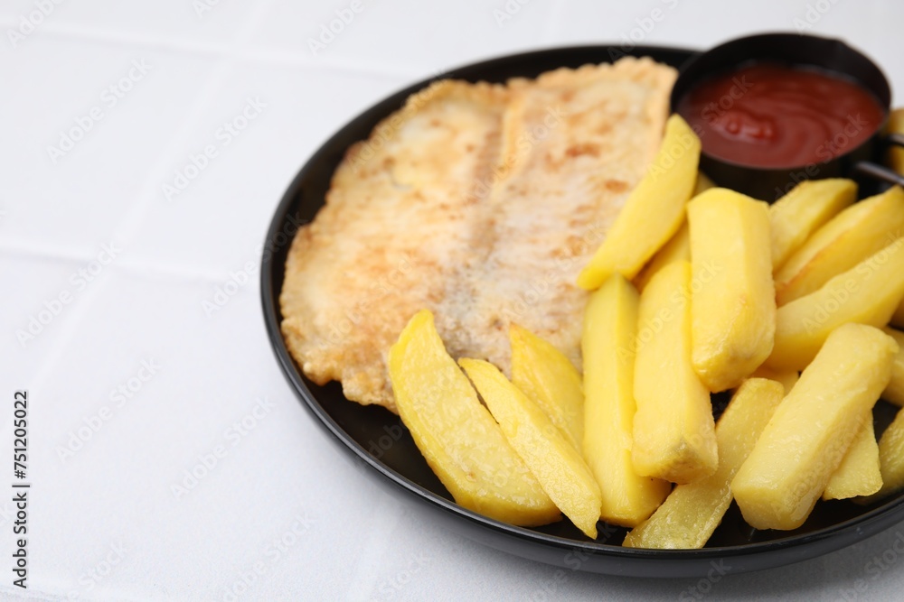 Delicious fish and chips with ketchup on white tiled table, closeup Delicious fish and chips with ketchup on white tiled table, closeup
