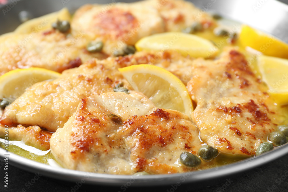Delicious chicken piccata with lemons in pot, closeup Delicious chicken piccata with lemons in pot, closeup