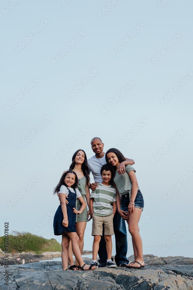 Family portrait after sunset on the rocks.