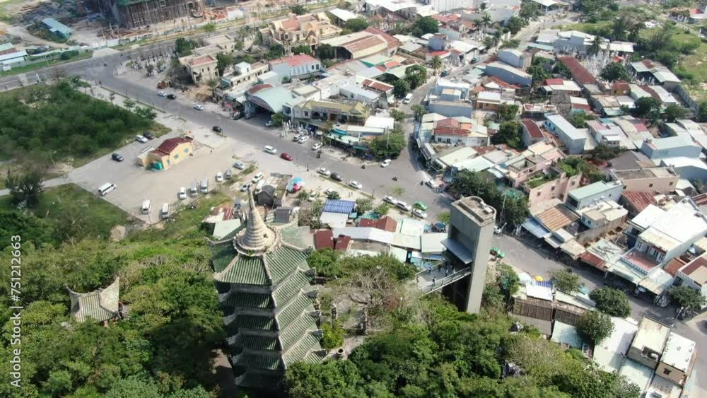 Drone aerial view in Vietnam flying over Da Nang coast city marble mountains with a temple pagoda next to the beach on a sunny day Drone aerial view in Vietnam flying over Da Nang coast city marble mountains with a temple pagoda next to the beach on a sunny day