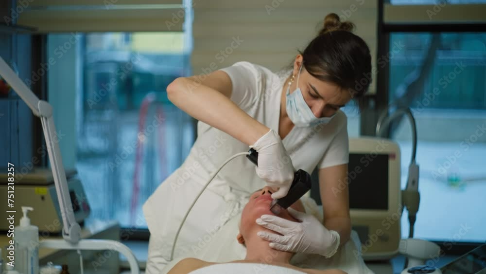A cosmetologist performs rejuvenating procedures on an elderly woman. Beauty procedures using devices in the salon. High quality 4k footage A cosmetologist performs rejuvenating procedures on an elderly woman. Beauty procedures using devices in the salon. High quality 4k footage