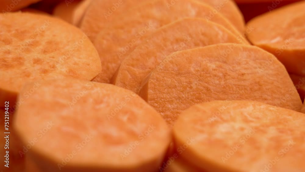 Sliced sweet potatoes (batata). Starchy uncooked raw ingredient. Close up. Rotation Sliced sweet potatoes (batata). Starchy uncooked raw ingredient. Close up. Rotation