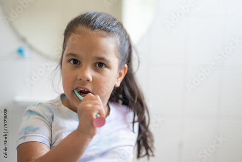 Girl brushing her teeth photo