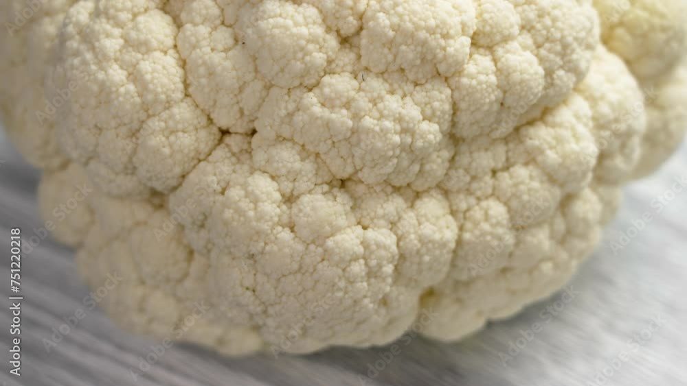 Organic Fresh Cauliflower Head on a cutting board close up. Rotation Organic Fresh Cauliflower Head on a cutting board close up. Rotation
