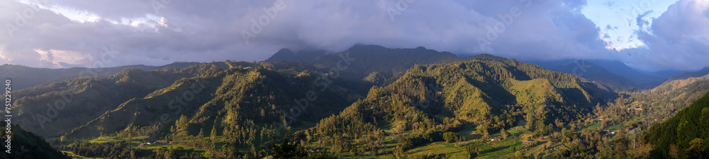 Picturesque view of green valley surrounded with mountains in daylight Picturesque view of green valley surrounded with mountains in daylight