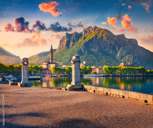 First sunlight glowing mountain peak and old buildings in Lecco town, city on the southeastern shore of Lake Como, Italy, Europe. Stunning sunrise in Italian Alps. Traveling concept background.
