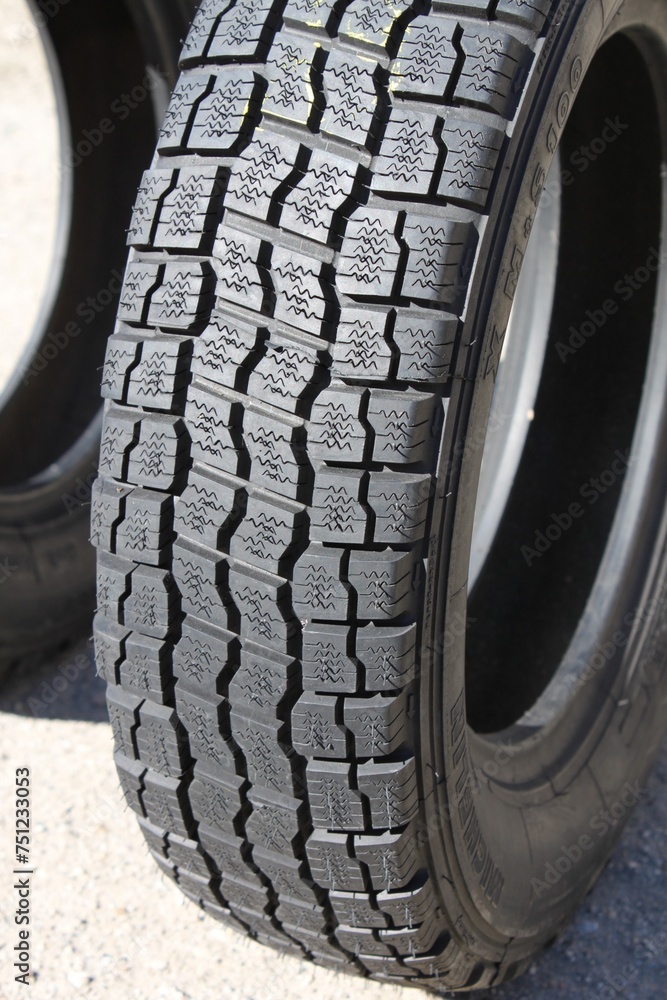 Tire, a vital component of a vehicle's anatomy, providing traction, stability, and cushioning against road surfaces.  - obrazy, fototapety, plakaty 