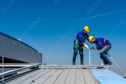 Roofer man helping hands to climbing on roof, work on height concept