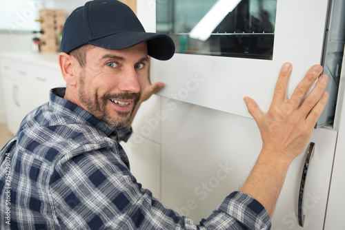 portrait of man fitting new oven