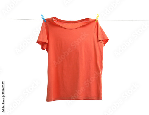 One orange t-shirt drying on washing line isolated on white